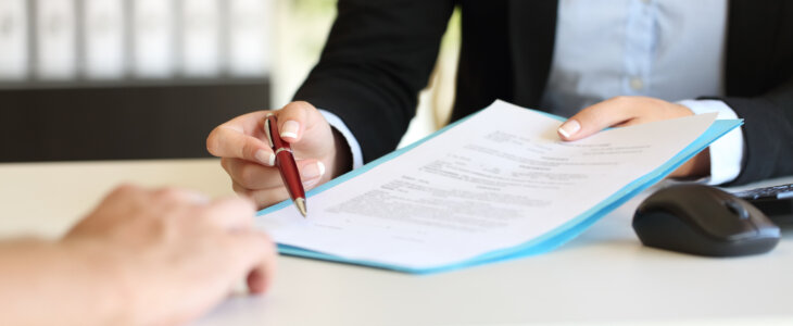 lawyer signing contract agreement with client